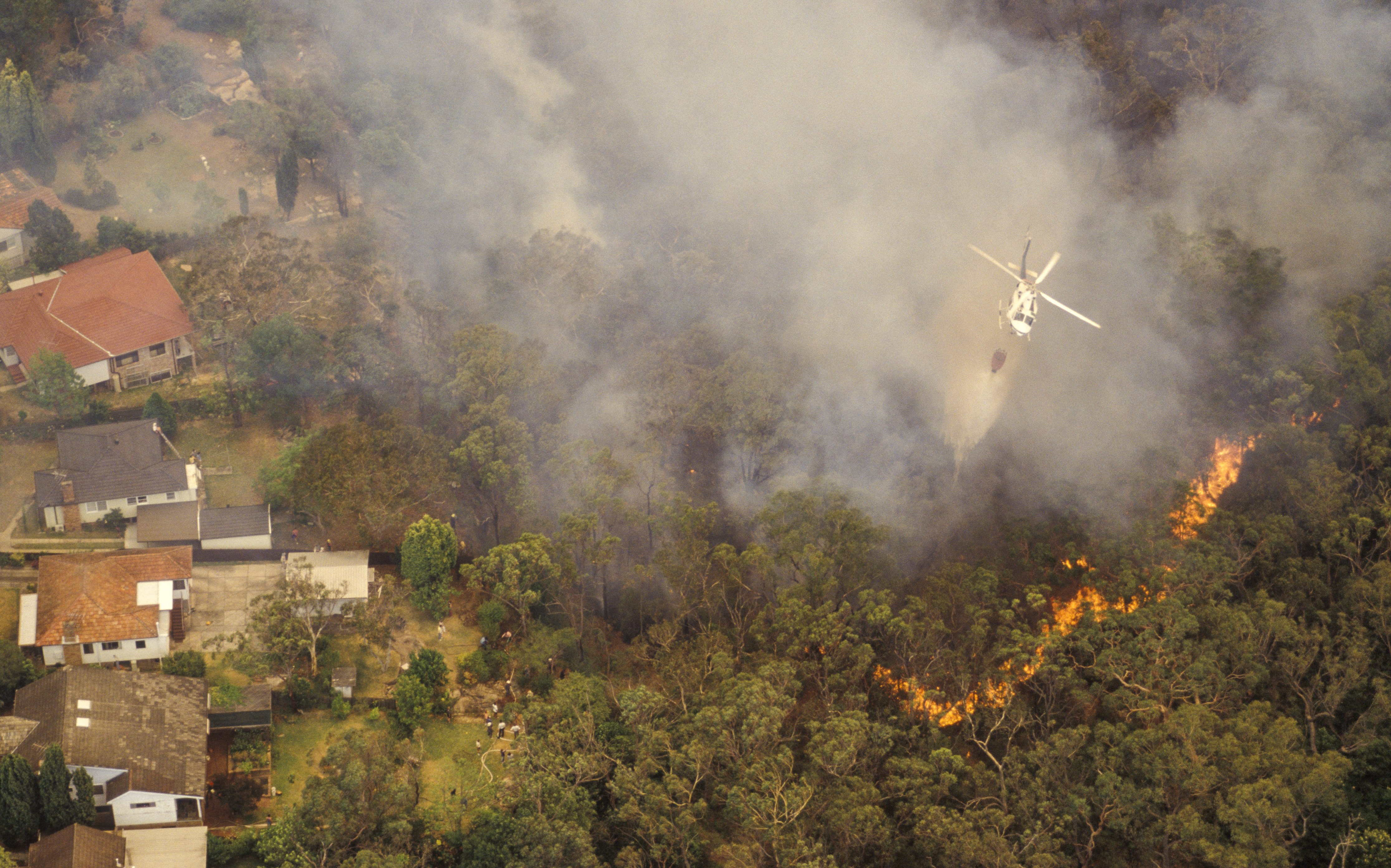 Aerial view of bushfire with a helicopter